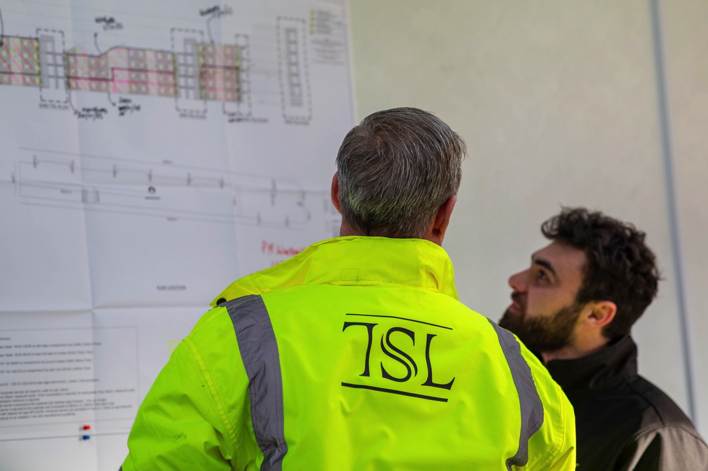 Photo of two TSL workers discussing a major works project.